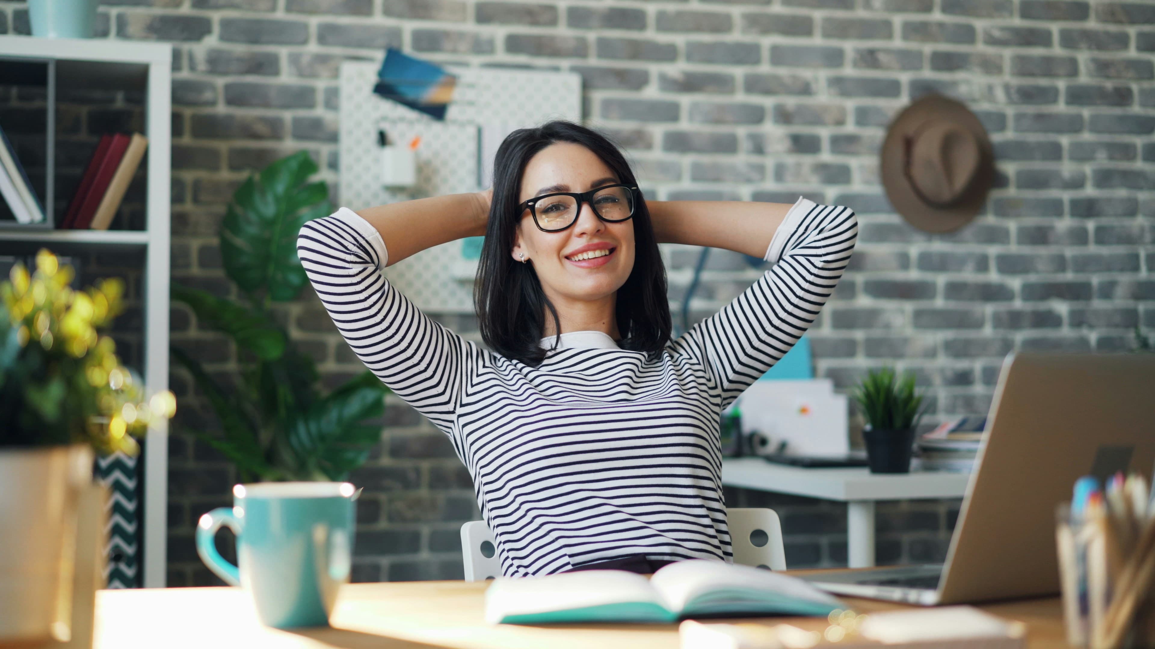 An employee relaxed at their desk after a breathwork session