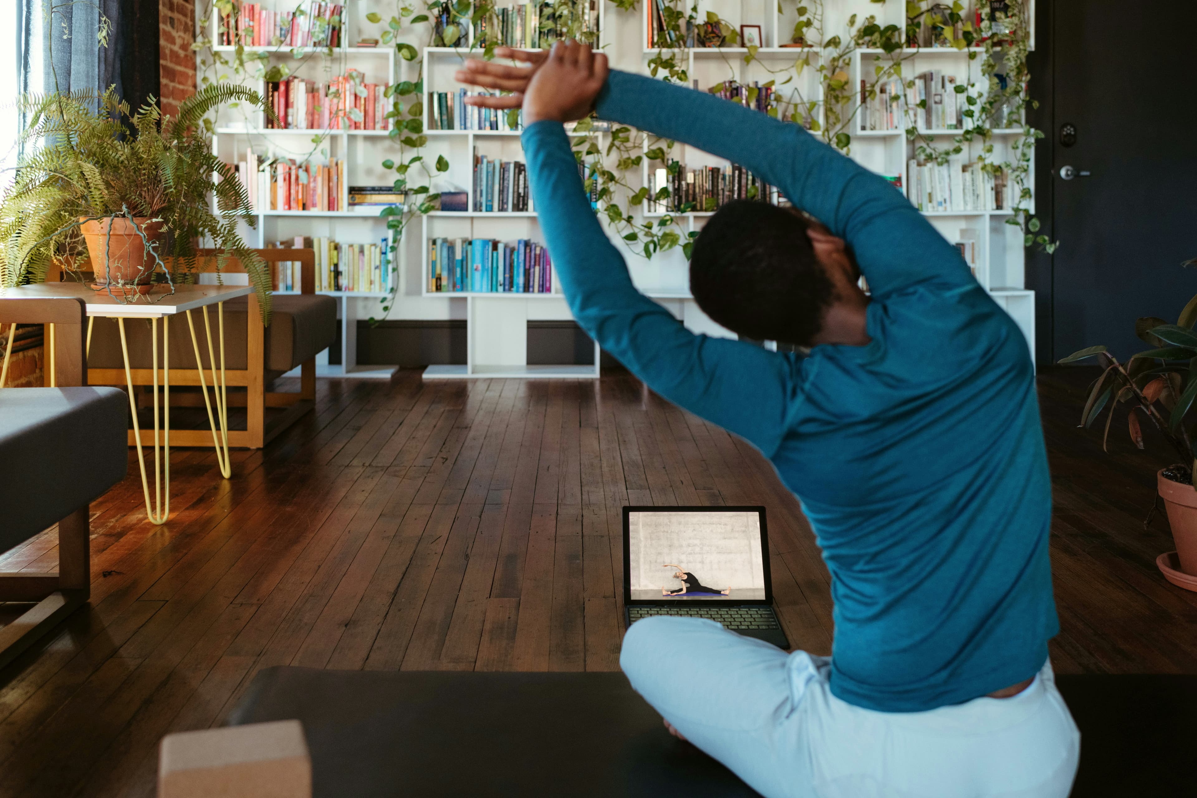 Joining a Velora chair yoga session remotely from a laptop at home